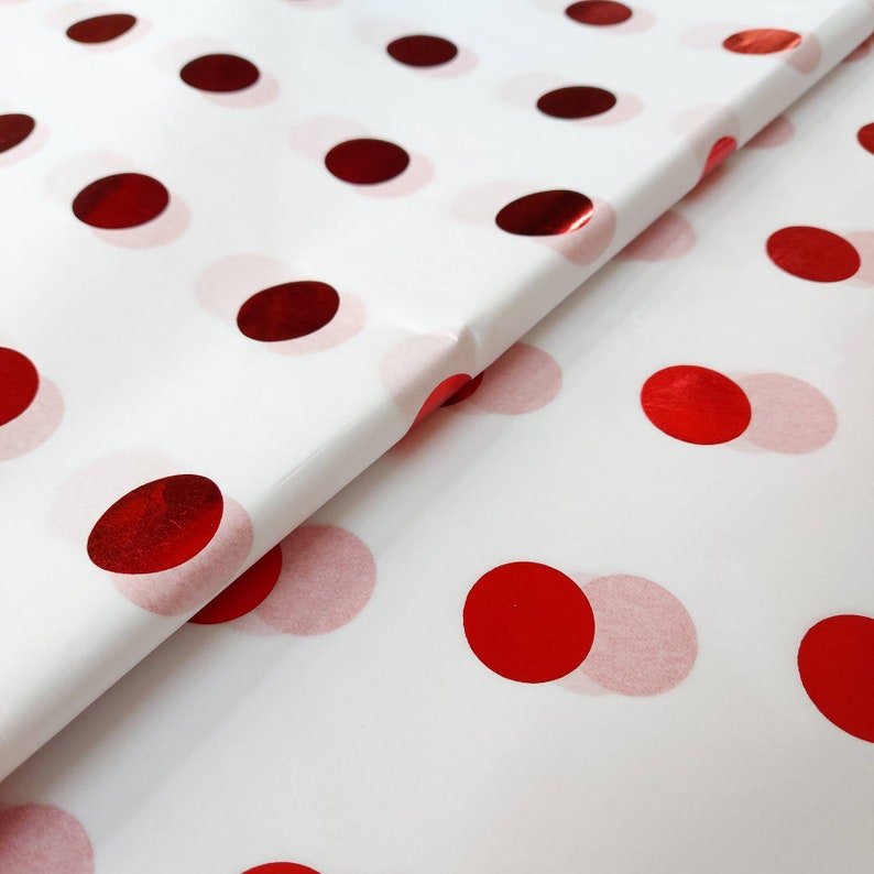 White tissue paper with red shiny spots