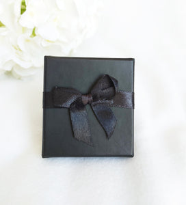 Black Card Ring Box with attached Satin Ribbon Bow and Foam Insert top